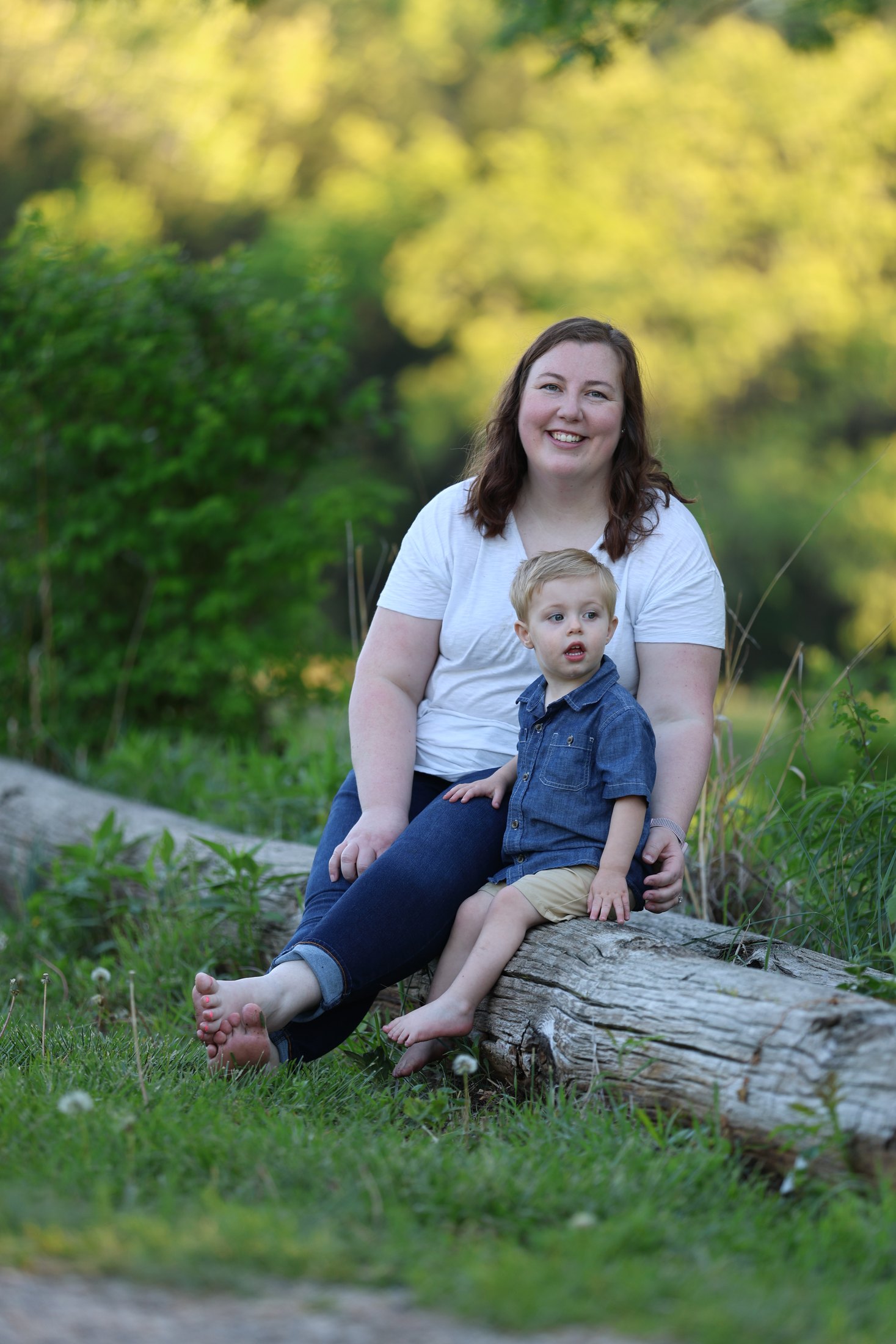 Mother and child portrait seated on a log