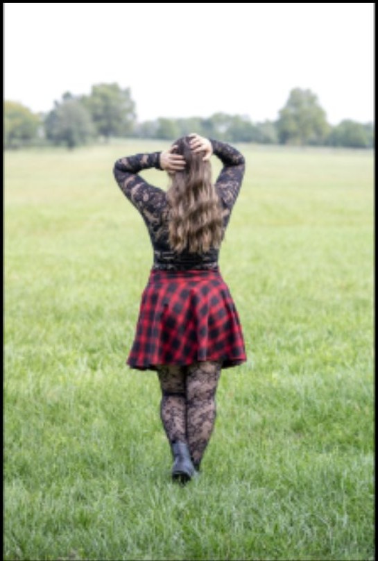 Outdoor portrait from behind in a plaid skirt