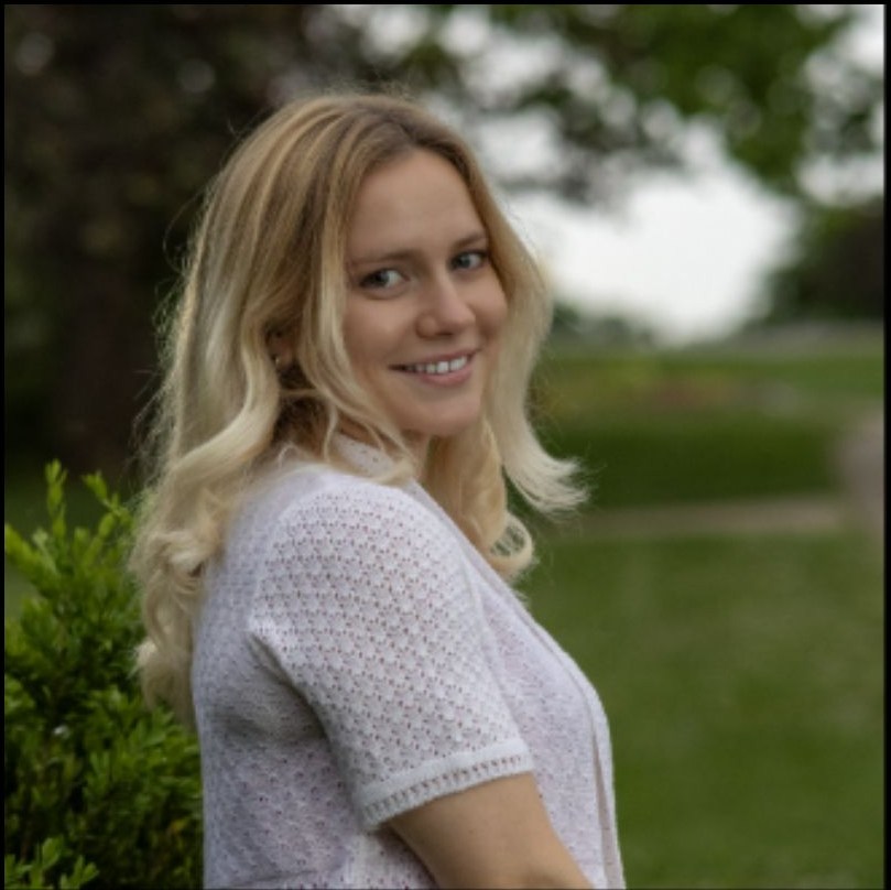 Outdoor smiling portrait in soft green light