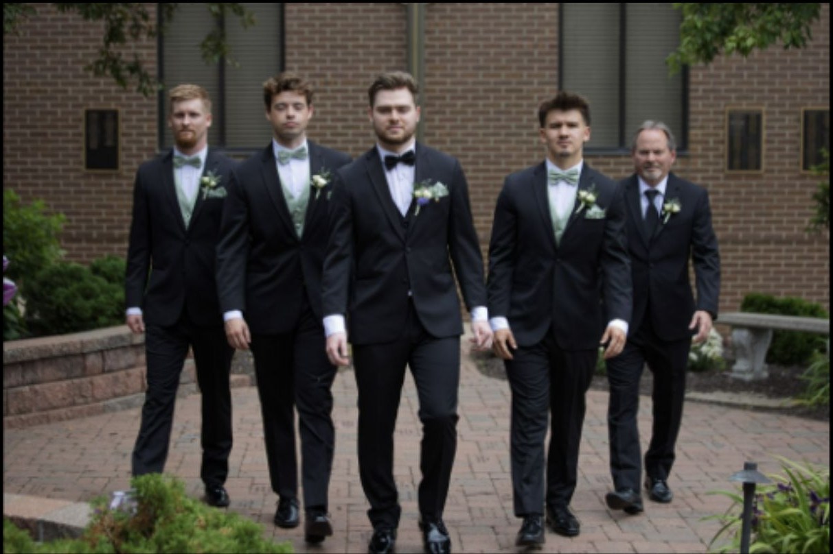 Groomsmen walking together outdoors before the ceremony