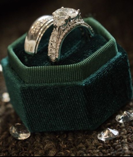 Wedding rings displayed in a green ring box