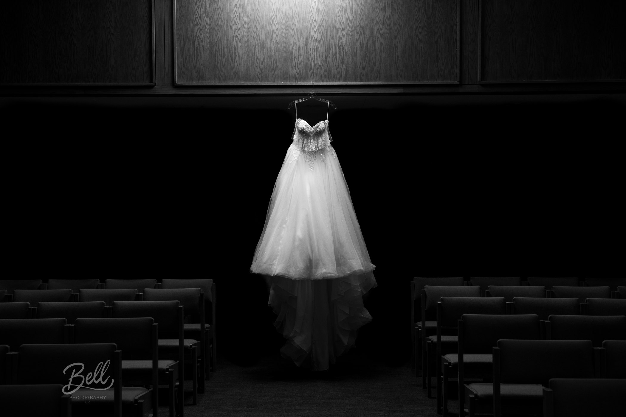 Wedding dress suspended above chapel seating