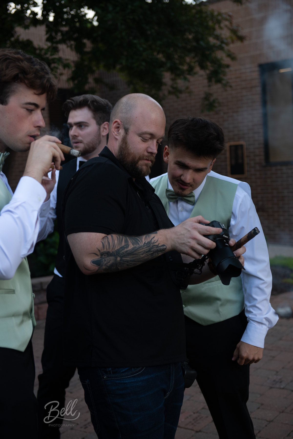 Wedding party reviewing a camera outdoors